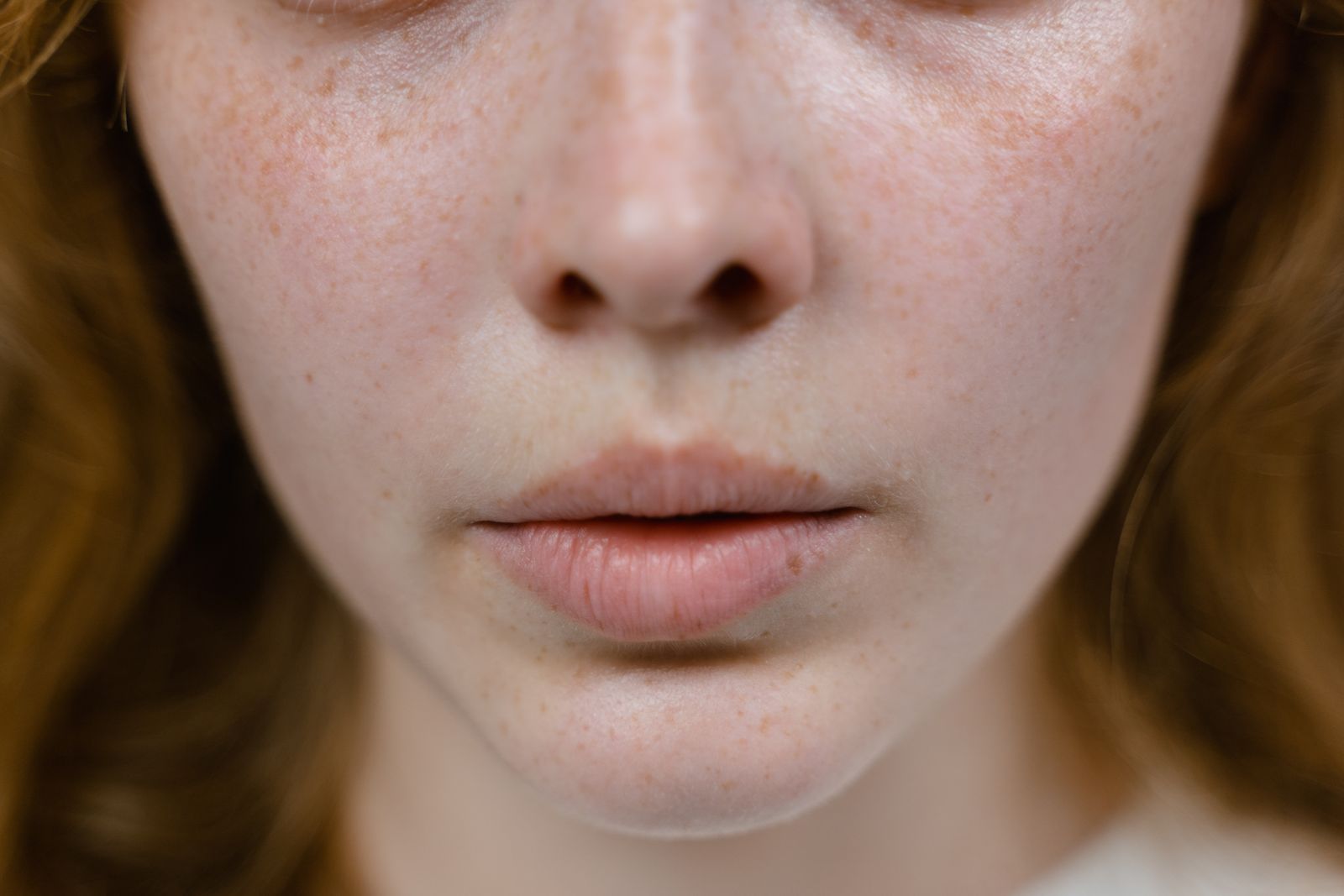 Detailed close-up showing natural freckles and skin texture